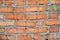 The texture of a wall composed of red brick