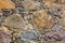 The texture of a wall of stones paved with concrete