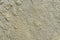 Texture of wet sand. Brown wet sand. Background of fine and wet sand. Sand background