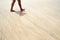 The texture of wet sand, surf. Man walking on the beach