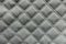 Texture of white quilted fabric with diamond pattern