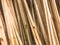 Texture of wooden brown diagonally tilted natural building boards sticks with knots. The background