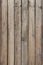 The texture of a wooden fence made of unpainted weathered wood. A high resolution. Vertical image