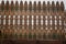 The texture of a wooden, textured fence decorated with unusual patterns.