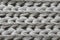 Texture of wool knitwear large knit, gray,  close-up.