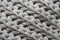 Texture of woolen knitwear with  large pattern `elastic band`, gray, vertical line, ,  close-up.