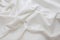 Texture of wrinkled, crumpled natural ivory fabric close-up. background for your mockup