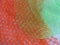Textured abstract background with striking bright orange and green fishnet pattern