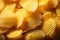 Textured background of crispy, golden potato chips, a delicious snack