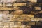 Textured background of old faded bricks stained with black oil. A brick gradient between dirty black and light yellow