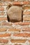 Textured background of old ruined brick wall with stone inside. Close-up view. Restored while preserving the destroyed elements of