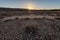 A textured barren rocky landscape at sunset