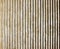 Textured cast concrete wall with vertical lines and striped design