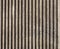 Textured cast concrete wall with vertical lines and stripes