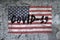 On the textured concrete wall with the American flag, the inscription : COVID-19. Concept: coronavirus and pandemic, natural disas