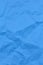 Textured crumpled blue paper background. Copyspace