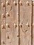 Textured detail of a antique door from a traditional Spanish house in Segovia, Spain. Medieval wooden doorway texture