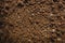 Textured fertile soil  for cultivation as background. The potting soil or peat is suitable for gardening and is one of the four