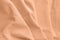 Textured folds of fabric in peach color