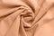 Textured folds of fabric in peach color