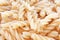 Textured Italian food background - uncooked fusilli pasta