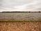 Textured Layers of a Sea Shore Overcast and Waves, sand and Pebbles