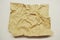 Textured obsolete crumpled packaging brown paper on a white background