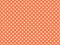 texturised white color polka dots over coral orange background