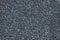 Texured roofing felt surface with many small grey stones