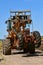 TFork lift with tractor suspended from the chains