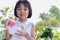 Thai Asian kid girl, age 4 to 6 years old, looks cute and bright. eating ice cream with hunger She relishes home-made ice cream.