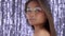 Thai asian model in studio with silver rain disco background and party makeup