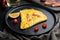 Thai  Asian omelette, fresh red chilli, brown and white crabmeat, lemon, Cheddar cheese, eggs, on plate, on black wooden table