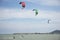 Thai athletes and foreigner people practicing sports and playing kiteboarding or sea kite in the ocean in Rayong, Thailand