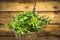 Thai Basil bunch in basket on old wooden