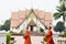 Thai Buddhist monks walking at front of Ubosot at Wat Phumin in morning time