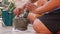 Thai chilli and garlic pounding in stone mortar with pestle. Woman preparing sauce for thai soup tom yam. Close Up. 4k