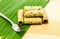 Thai coconut cracker roll on banana leaf.