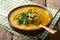 Thai curry pumpkin soup with peanuts, coconut milk and cilantro