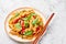 Thai Drunken Noodles or Pad Kee Mao at white marble background. Drunken Noodles is thai cuisine dish