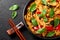 Thai Drunken Noodles or Pad Kee Mao in white plate at black slate background. Drunken Noodles is thai cuisine dish