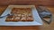 Thai egg roti pancakes on a white ceramic plate and with a gray mask placed side by side on a wooden bar counter.