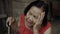 Thai elderly woman in round-necked sleeveless collar with headache and worried stressed face in wooden home
