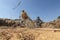 Thai farmer threshing by beating rice to separate seed.