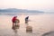 Thai farmer washing Bean Sprouts in Mekong River at sunrise. Bean Sprouts in bamboo basket. Organic vegetables. Thai-Laos border