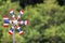 Thai flag wind turbine, blurred natural forest background, the wind blows through, causing the propeller to rotate, free space in