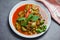 Thai food curry soup on white plate - red curry pork cuisine asian food on the table background