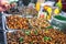 Thai food deep fried spicy silk worms, insects at night street market in Phuket, Thailand