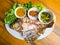 Thai food, Fresh fish grilled with salt and dips in on wooden table by
