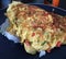 Thai food omelette topped with rice